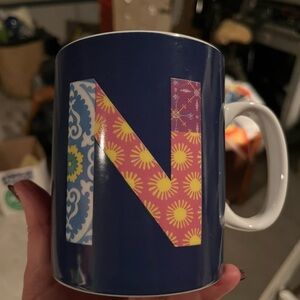 Navy & multi-coloured floral and sun design mug with letter “N”